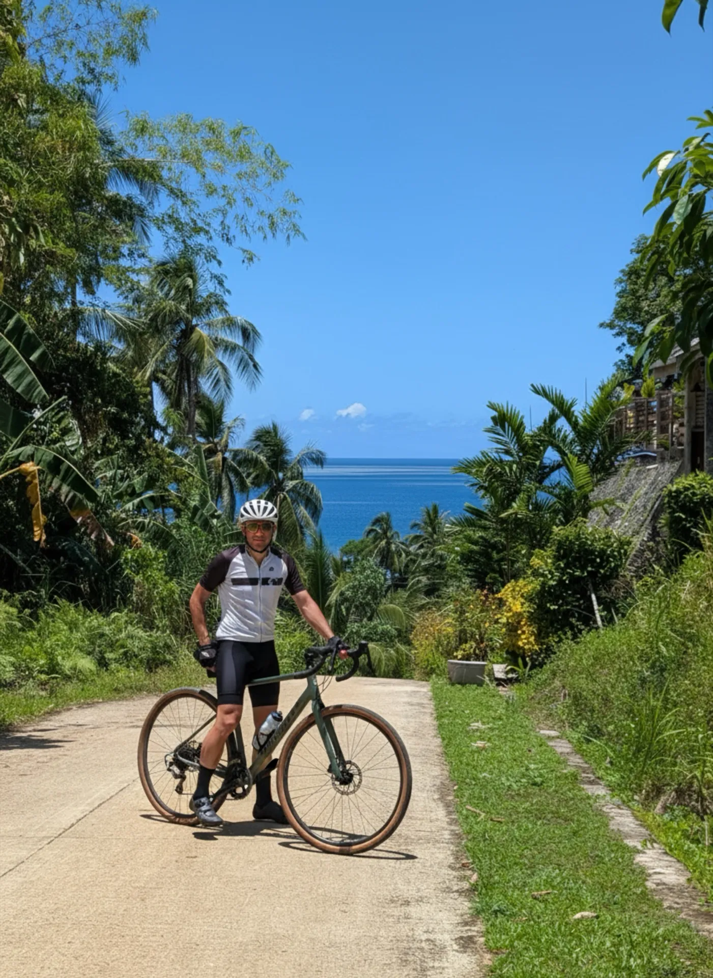 Cyclist with a gravel bike on a quiet coastal road, Siargao